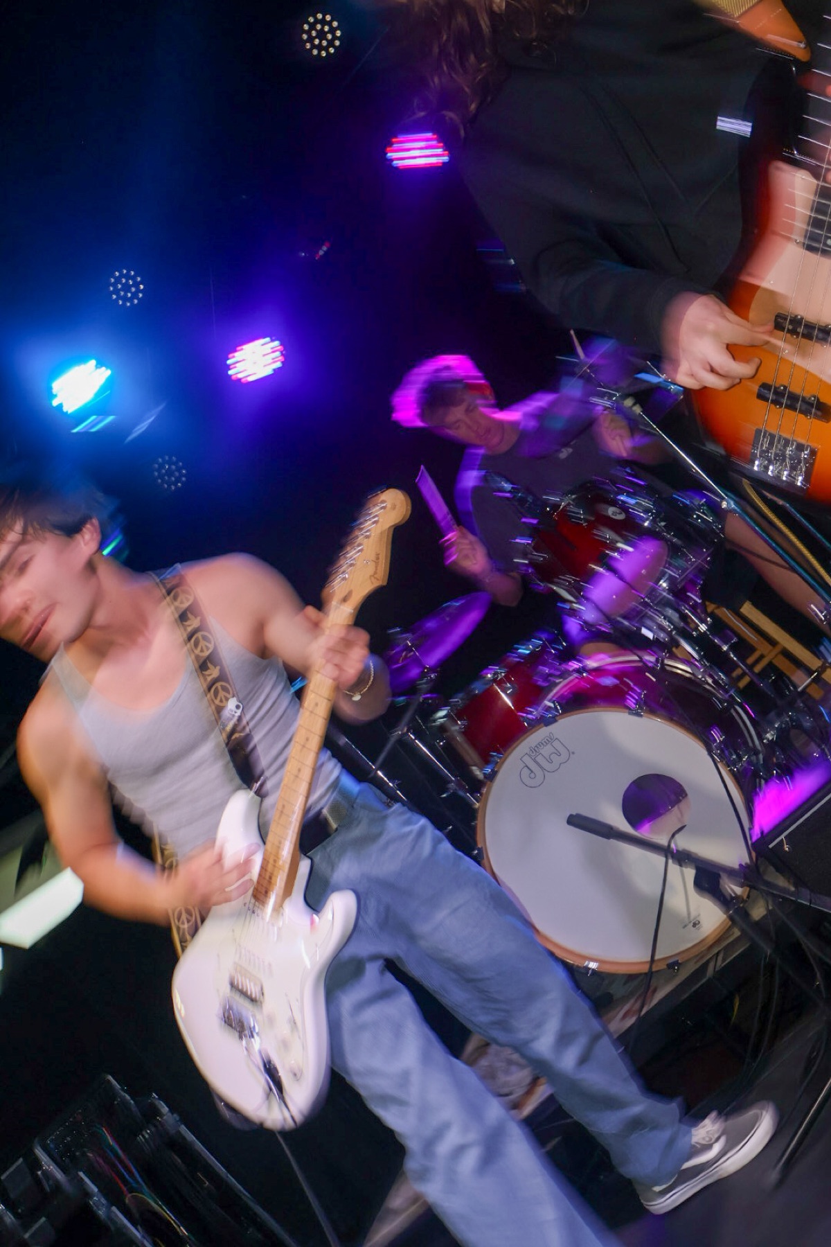 Zayah mid-stomp with guitar